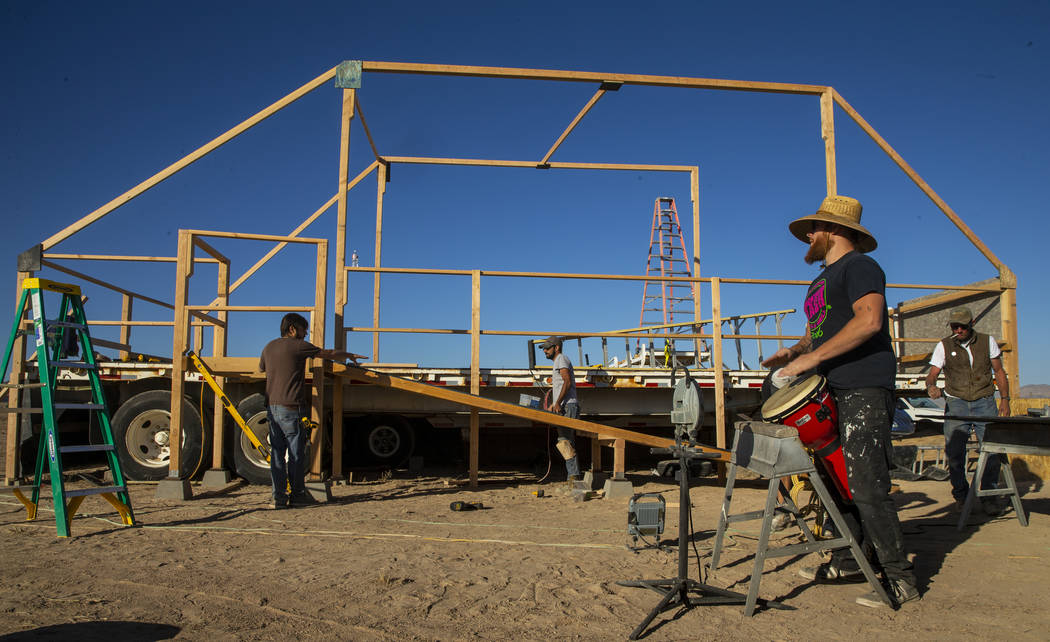 Wily Savage lead singer Alon Burton plays a conga drum as the construction crew begins work on ...