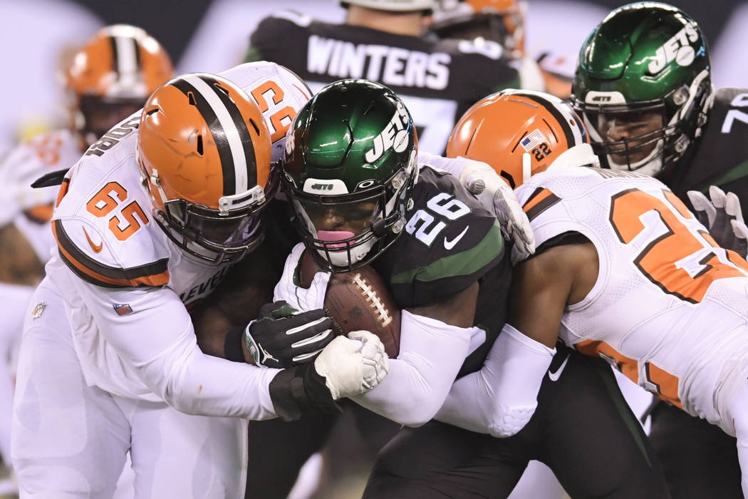 Cleveland Browns' Larry Ogunjobi (65) and Eric Murray (22) tackle New York Jets' Le'Veon Bell ( ...