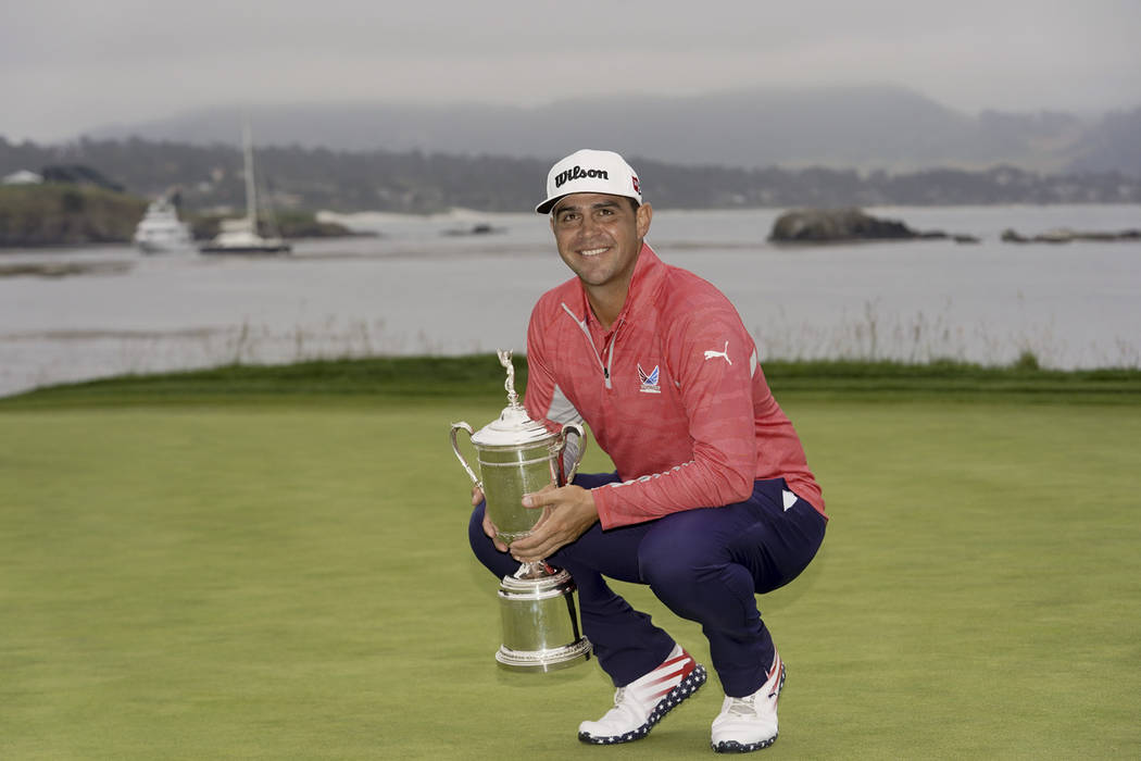 Gary Woodland posses with the trophy after winning the U.S. Open Championship golf tournament S ...