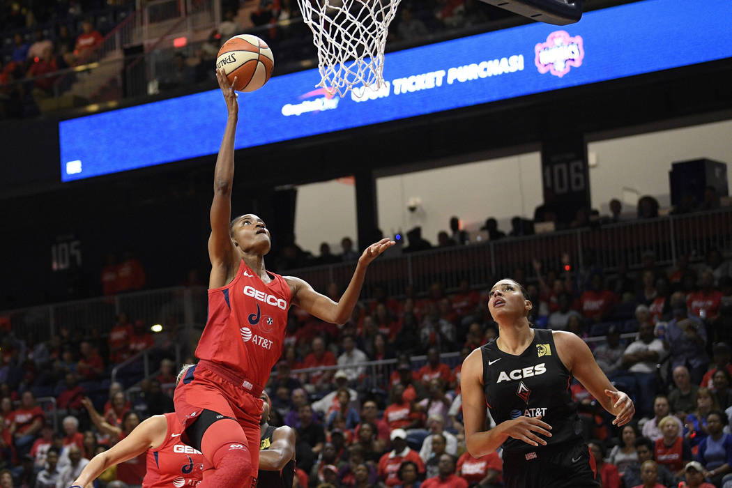 Washington Mystics forward LaToya Sanders, left, goes to the basket against Las Vegas Aces cent ...