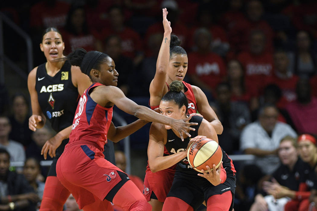 Las Vegas Aces guard Kayla McBride, right, tries to get past Washington Mystics forward LaToya ...