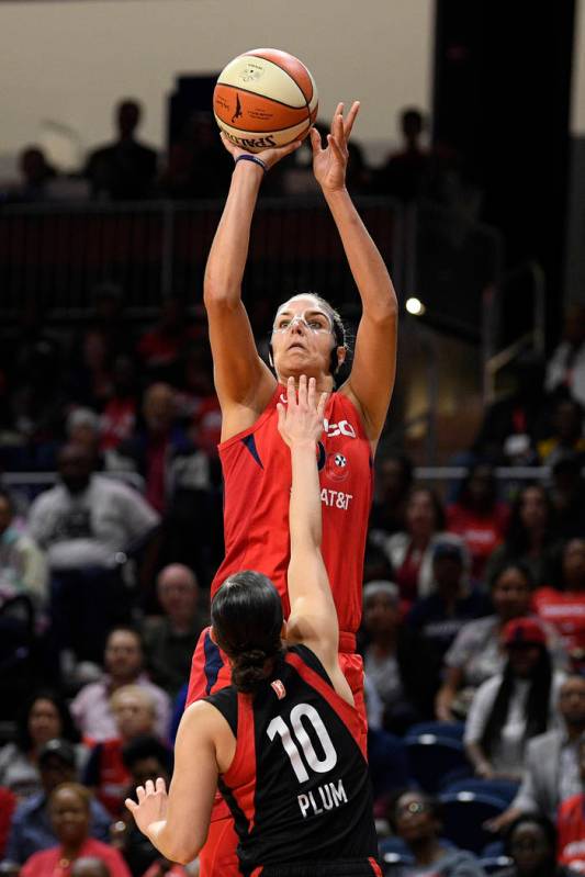 Washington Mystics forward Elena Delle Donne shoots over Las Vegas Aces guard Kelsey Plum (10) ...