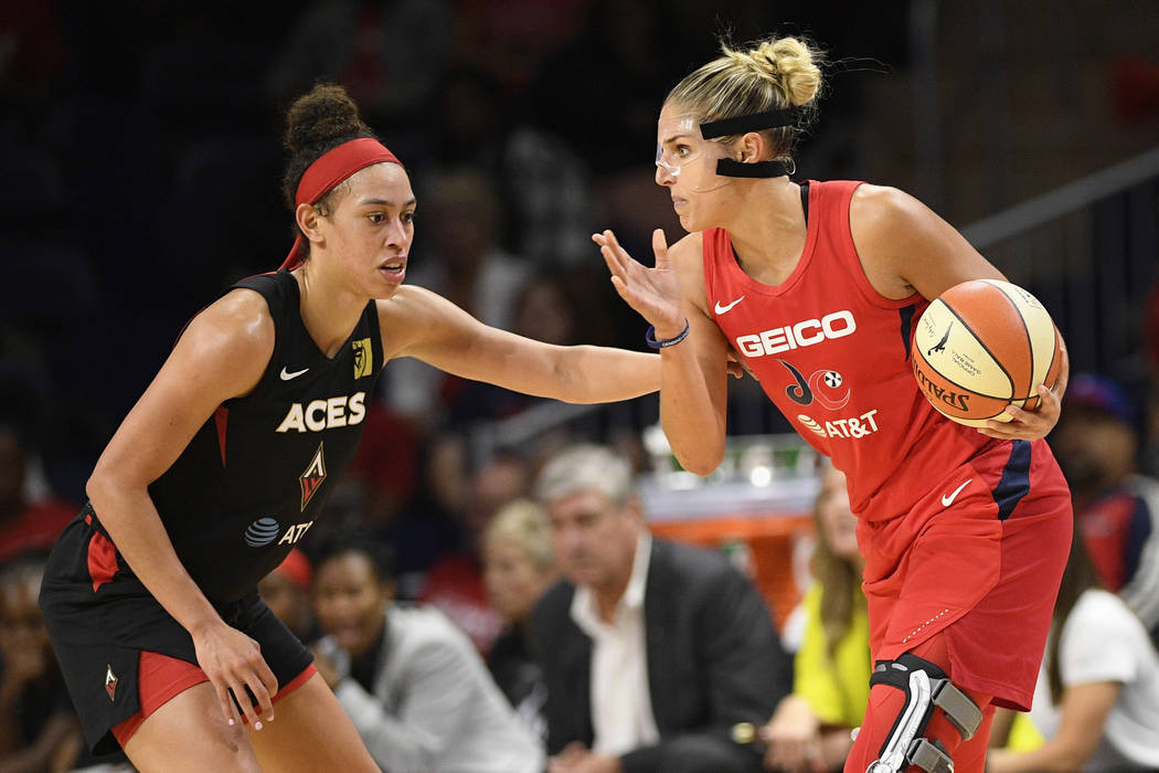 Washington Mystics forward Elena Delle Donne, right, handles the ball as Las Vegas Aces forward ...