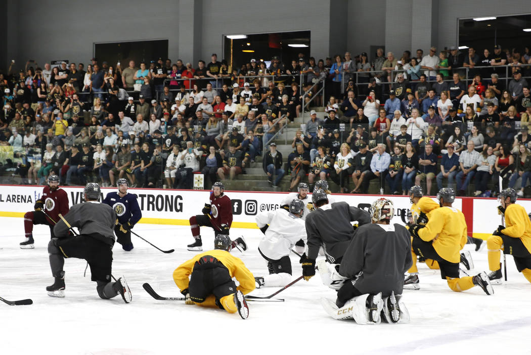 Fans watch as Golden Knights players stretch during team practice at City Center Arena on Wedne ...