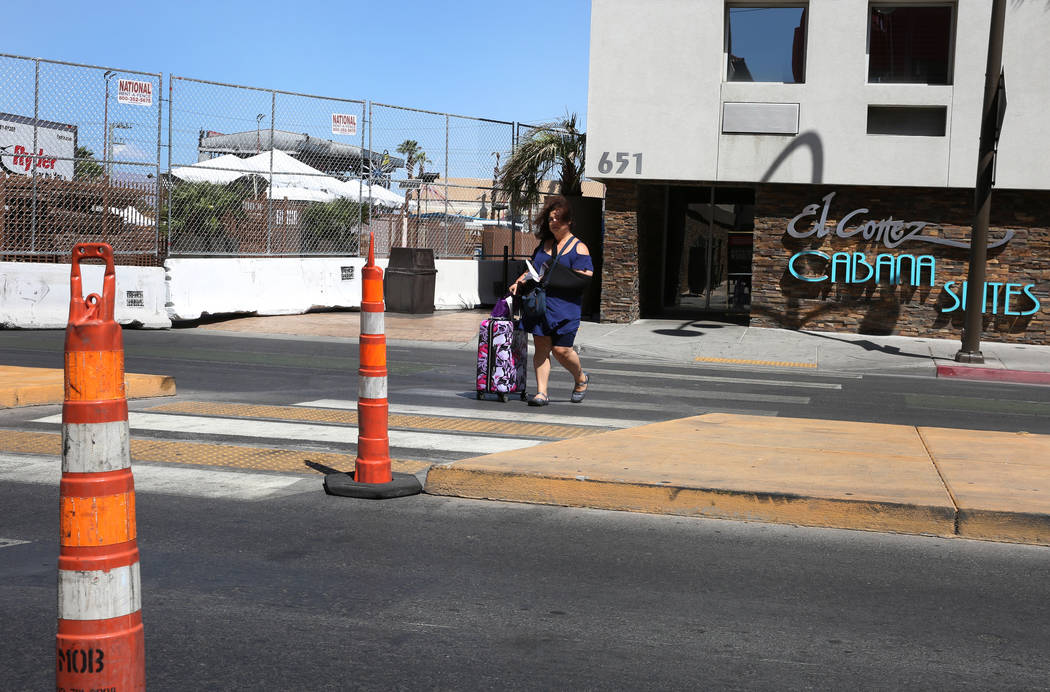 A guest at El Cortez Cabana Suites navigates through Ogden Street where the street is closed fo ...