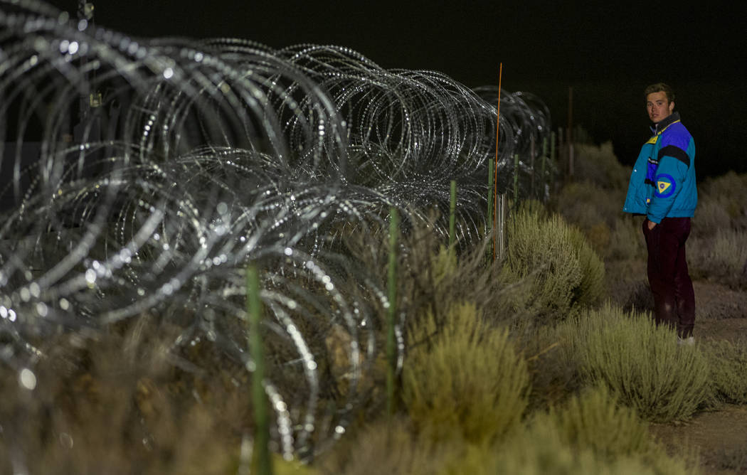 Michael Fortner of Cincinnati wanders along the fence line near the back gate of Area 51 in hom ...