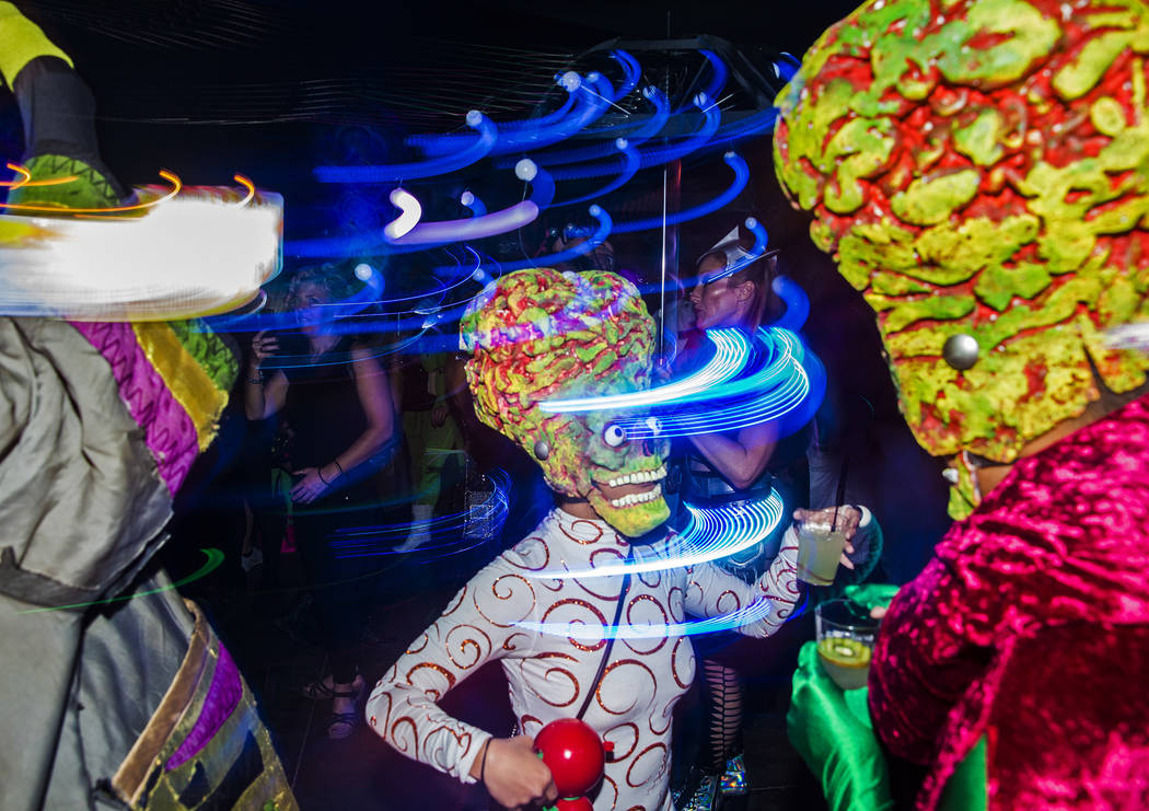 Attendees dressed as characters from the movie "Mars Attacks!" dance during a pre-party for Sto ...