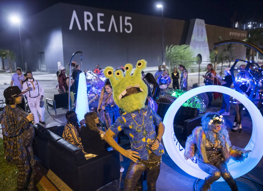 Alien-themed party goers socialize outside during a pre-party for Storm Area 51 on Thursday, Se ...