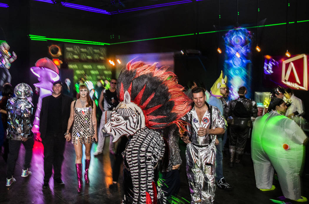 Alien-themed party goers socialize during a pre-party for Storm Area 51 on Thursday, Sept. 19, ...