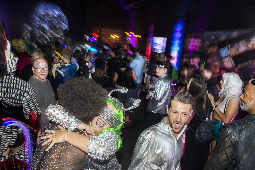 Alien-themed party goers socialize during a pre-party for Storm Area 51 on Thursday, Sept. 19, ...