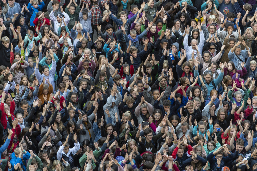 People attend a 'Fridays For Future' rally in Freiburg, Germany, Friday, Sept. 20, 2019. Protes ...