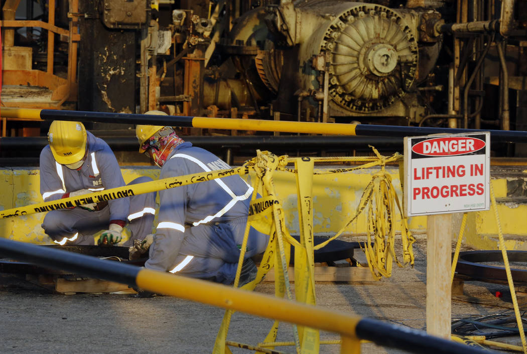 During a trip organized by Saudi information ministry, workers fix the damage in Aramco's oil p ...