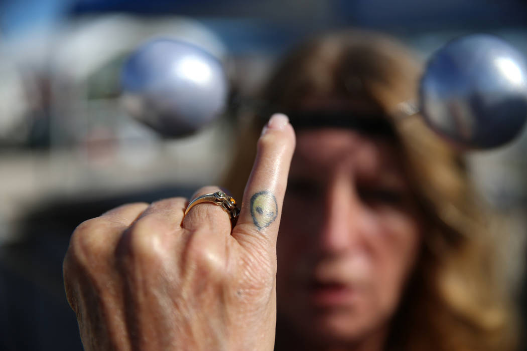 Trip Barrios of Las Vegas shows the alien tattoo on her finger while attending the Alien Baseca ...