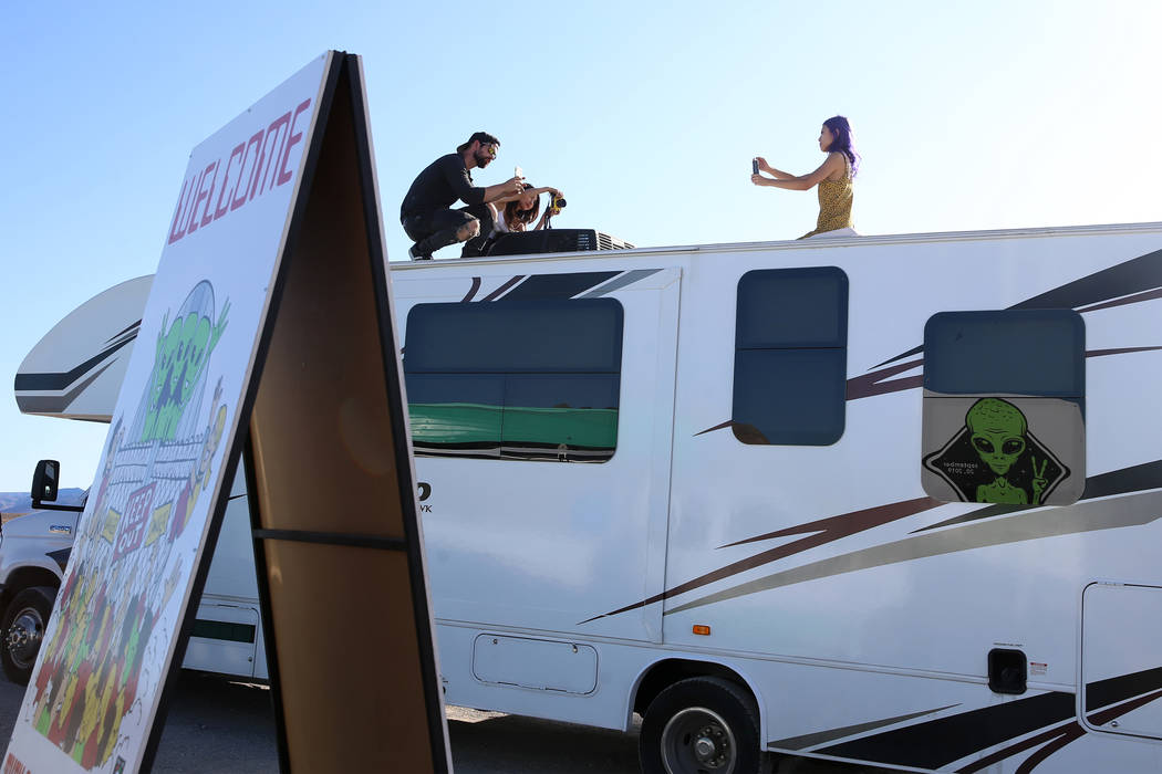 People takes photos outside of the Alien Research Center in Hiko, Nev., during the Alien Baseca ...