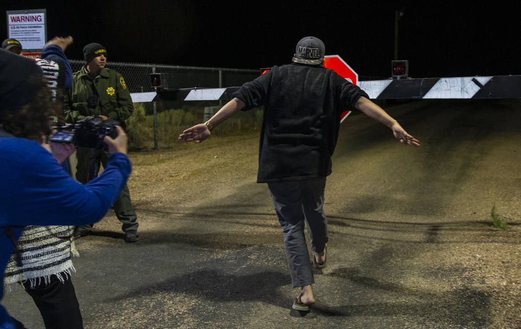 An attendee runs toward the back gate of Area 51 in homage to the original Storm Area 51 idea a ...