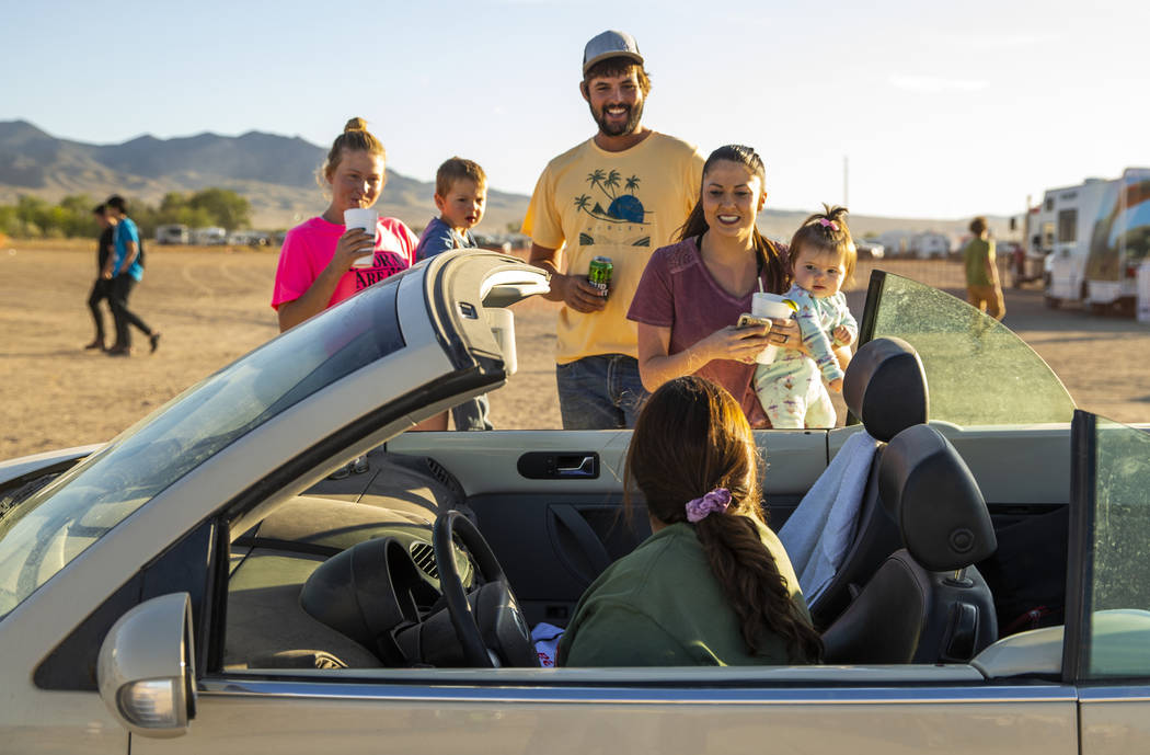 Friends stop and chat with Connie West, in car, of the Little A'Le'Inn during the Alienstock fe ...
