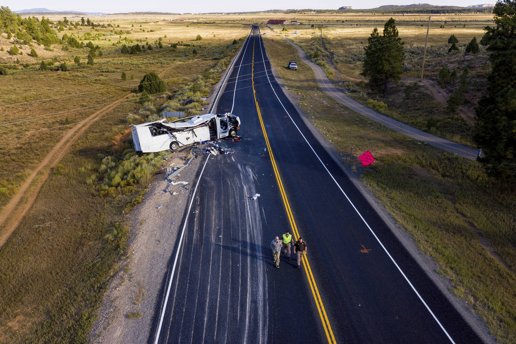 The remains of a bus that crashed while carrying Chinese-speaking tourists lie along State Rout ...