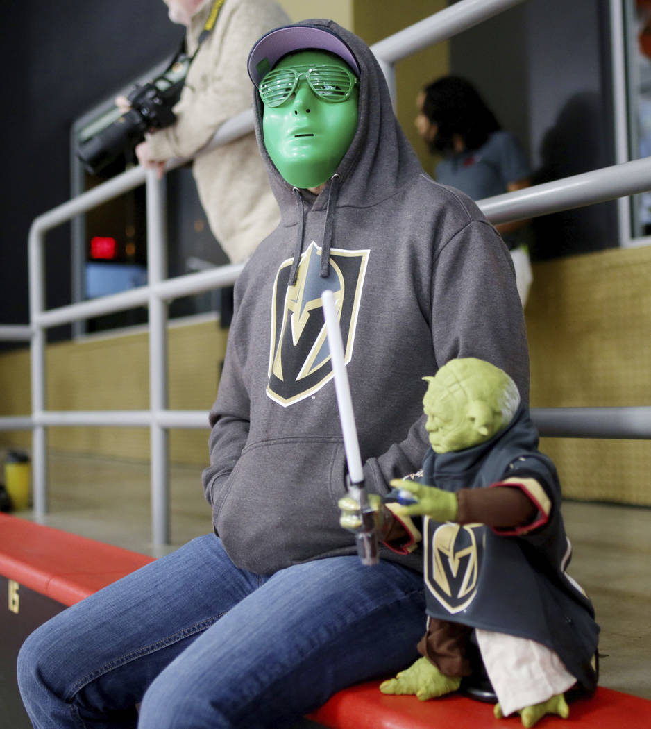 Las Vegas local Randall Keller watches the Golden Knights practice during an alien costume cont ...
