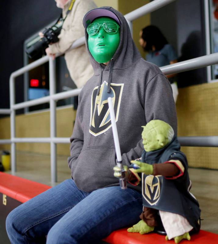 Las Vegas local Randall Keller watches the Golden Knights practice during an alien costume cont ...