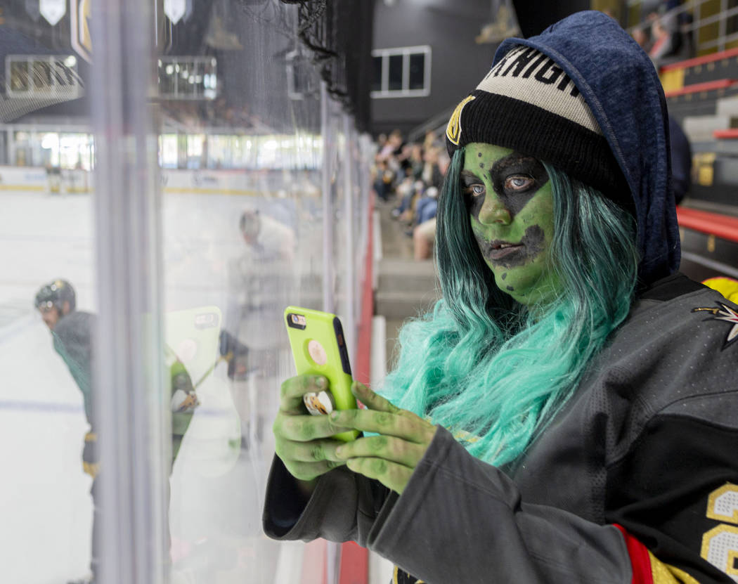 Las Vegas local Jaimee Thompson watches the Golden Knights practice during an alien costume con ...