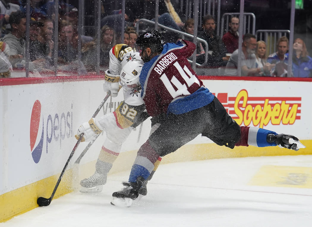 Colorado Avalanche defenseman Mark Barberio (44) hits Vegas Golden Knights left wing Tomas Nose ...