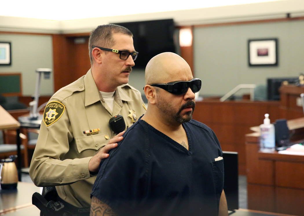 Gustavo Ramos-Martinez, convicted of killing two elderly people in 1998, is led out of the cour ...