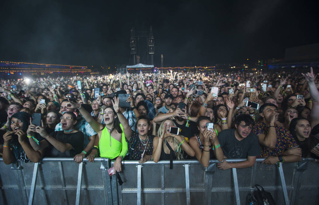 Fans react as Billie Eilish, not pictured, performs at the downtown stage during the first day ...