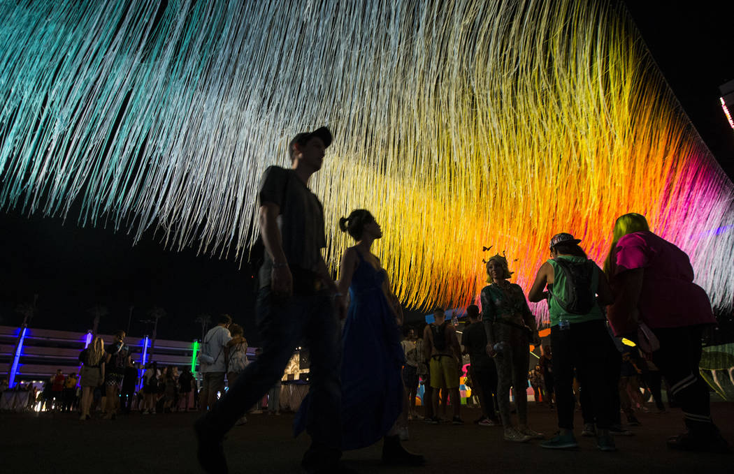 Attendees pass by an art installation by Hot Tea during the first day of the Life is Beautiful ...