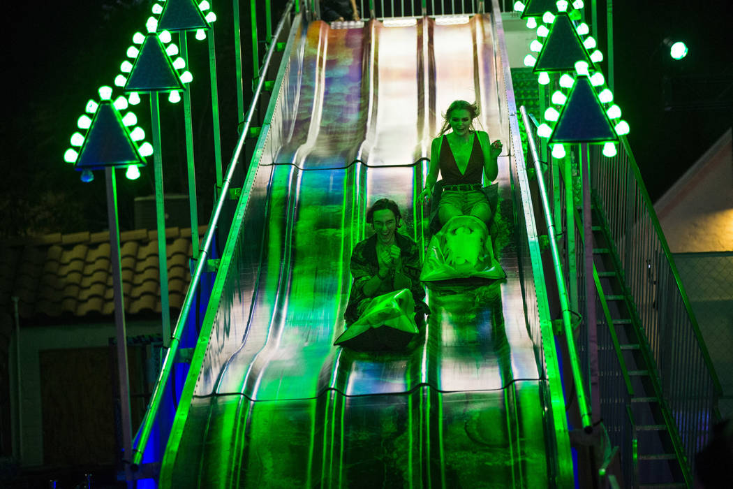 Massimo Greco, left, and Ryan Wiegand, both of Las Vegas, go down a slide during the first day ...