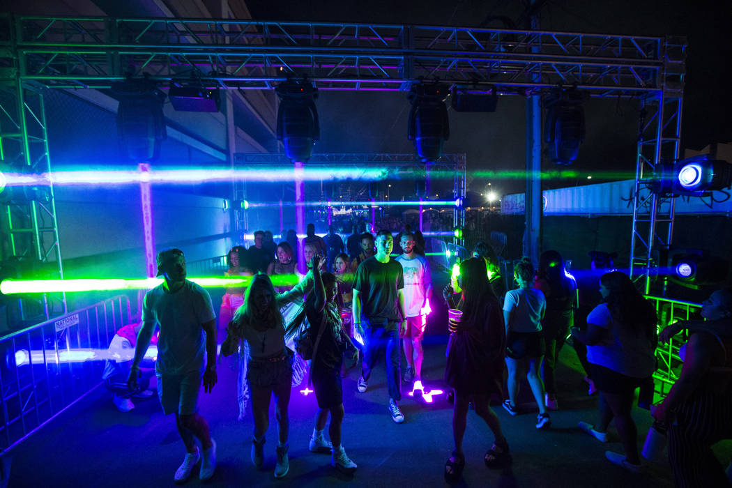 Attendees pass through an illuminated walkway during the first day of the Life is Beautiful fes ...