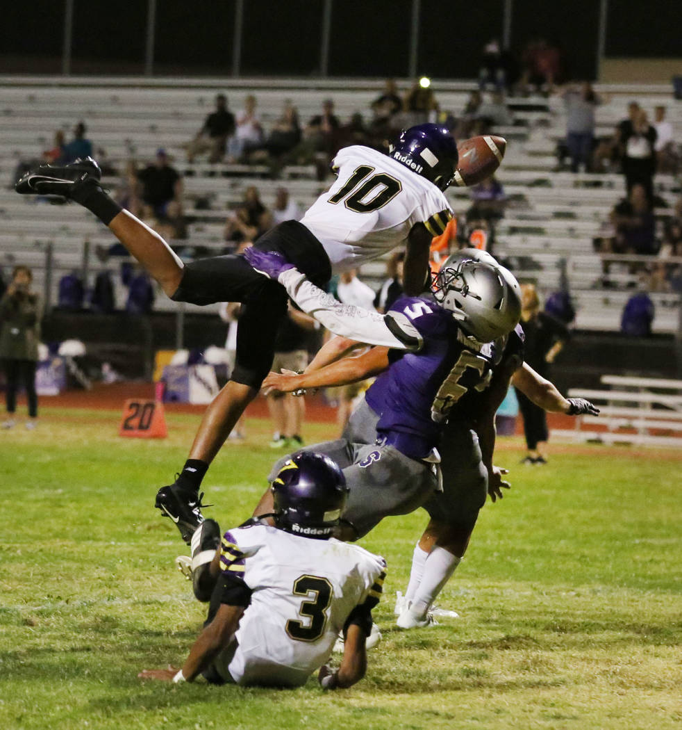 Durango High's wide receiver Dalin Knighten (10) defended by Silverado High's John Agounke (6) ...