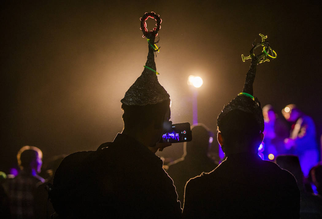 Festivilgoers listen to DJ Naavi on the EDM stage on night two of the Alienstock festival on Fr ...