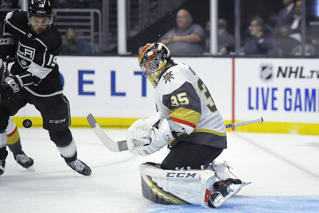 Vegas Golden Knights goaltender Oscar Dansk, right deflects a shot as Los Angeles Kings left wi ...