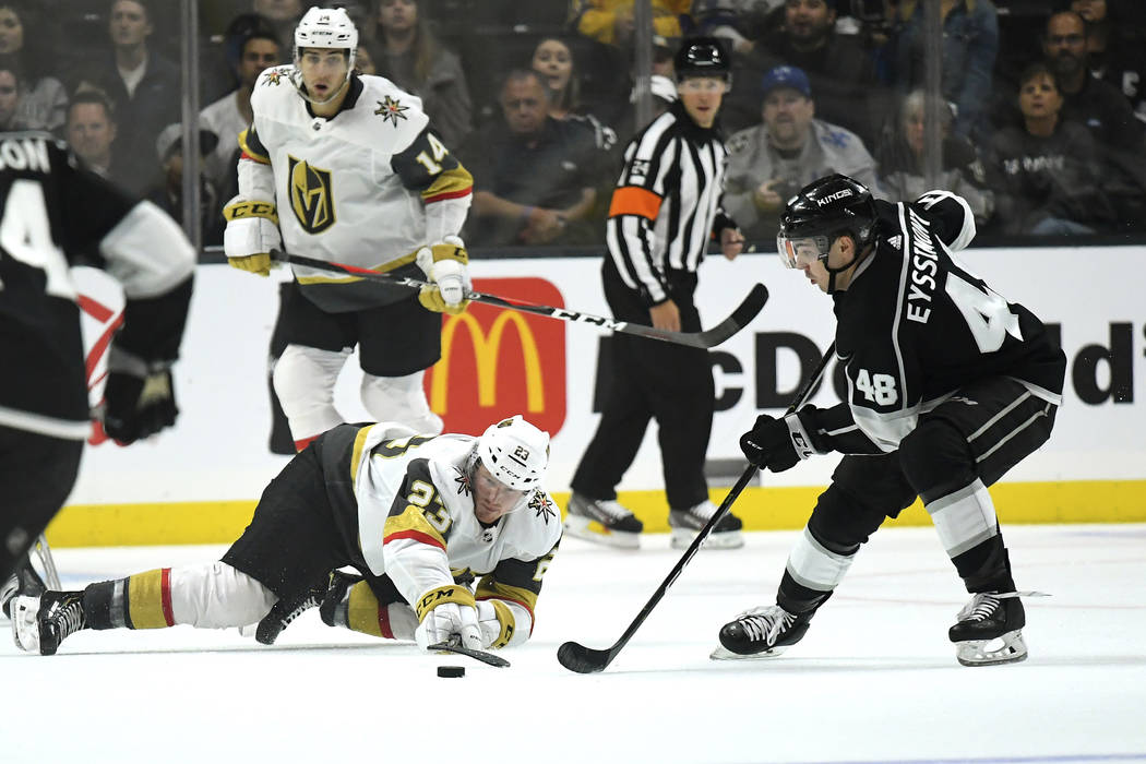 Vegas Golden Knights center Patrick Brown, lower left, passes the puck while under pressure fro ...