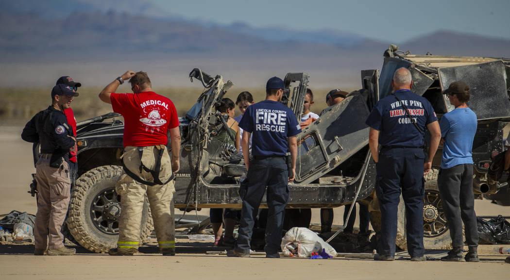 Emergency and medical personnel work the scene of a vehicle rollover with injuries on the salt ...