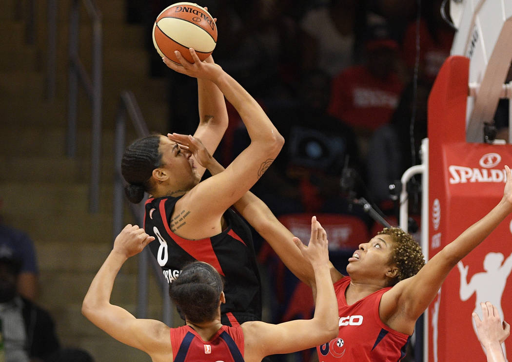 Las Vegas Aces center Liz Cambage (8) shoots above Washington Mystics forward Aerial Powers (23 ...