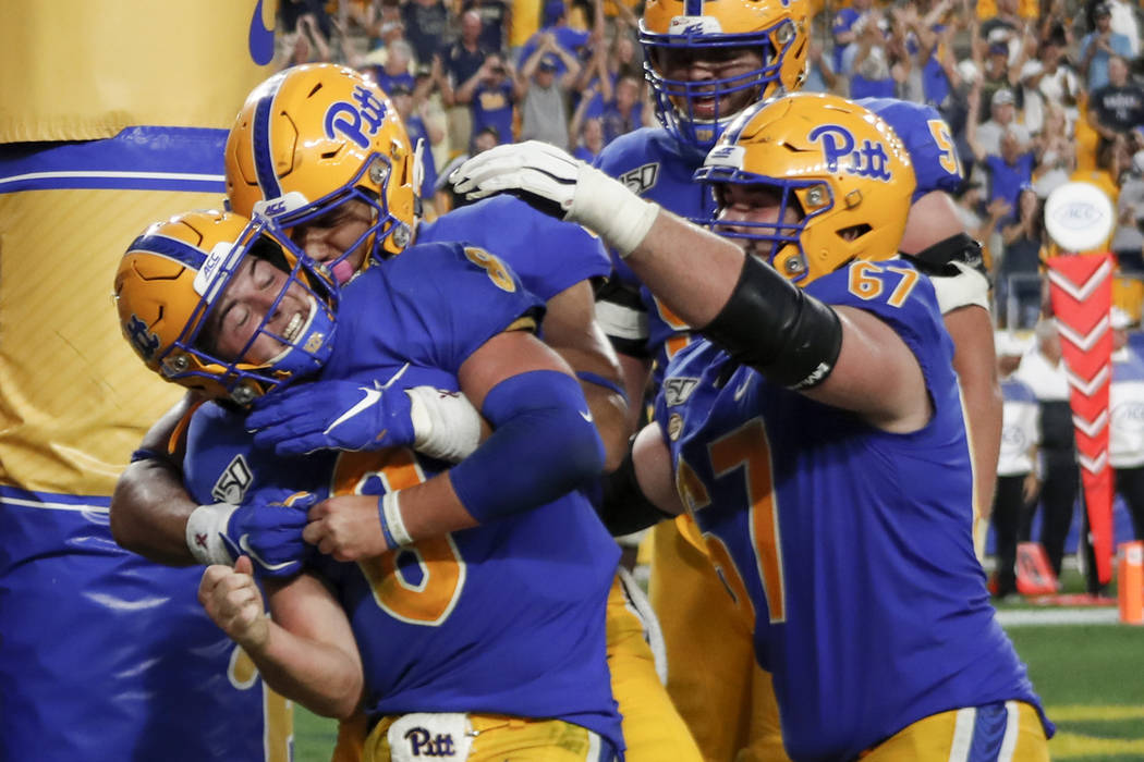 Pittsburgh quarterback Kenny Pickett (8) celebrates with teammates after he caught a pass for a ...