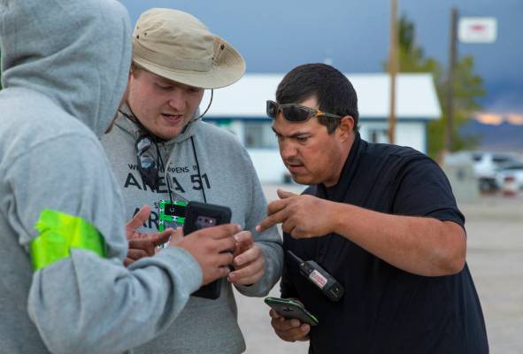 Volunteers Javy Morales, from left, and Brandon Misciagna work on parking details with Cody The ...