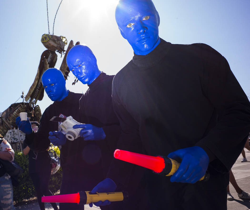 Members of the Blue Man Group roam the crowd during day 2 of the Life is Beautiful festival in ...
