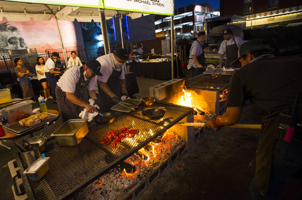 Food is prepared at The Cookout, a live fire cooking experience curated by Chef Justin Kingsley ...