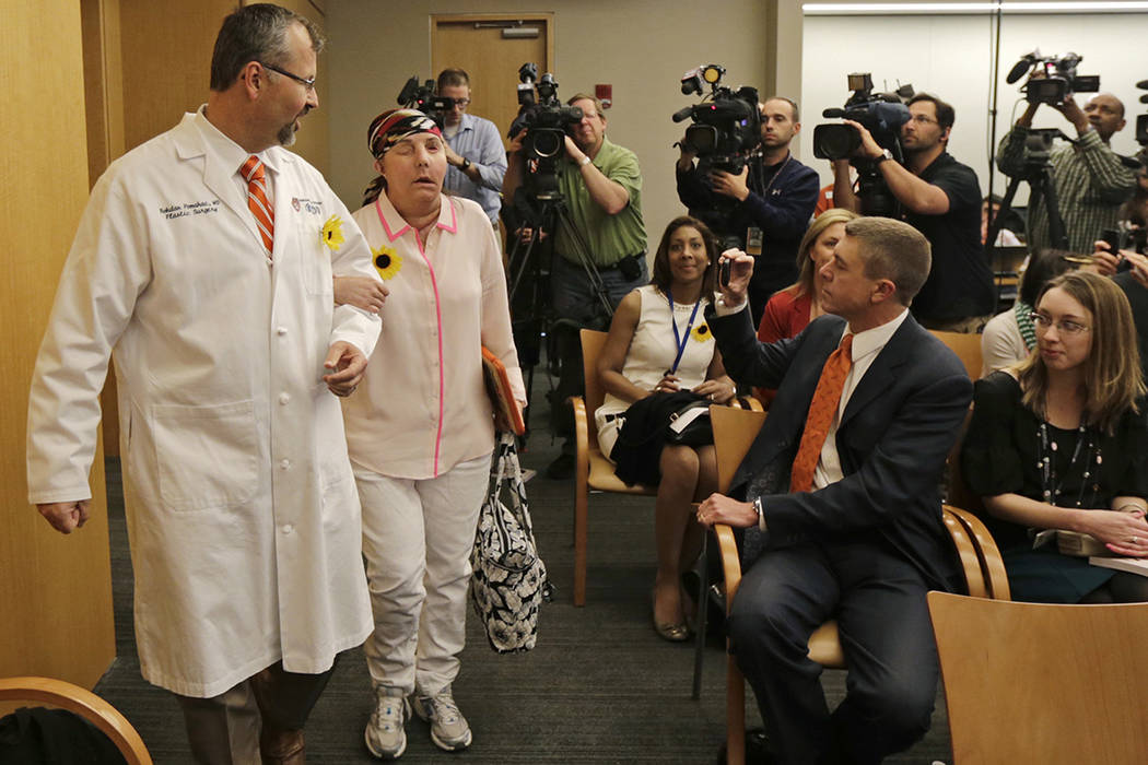 Carmen Blandin Tarleton, of Thetford, Vt,, is escorted by her surgeon Dr. Bohdan Pomahac while ...