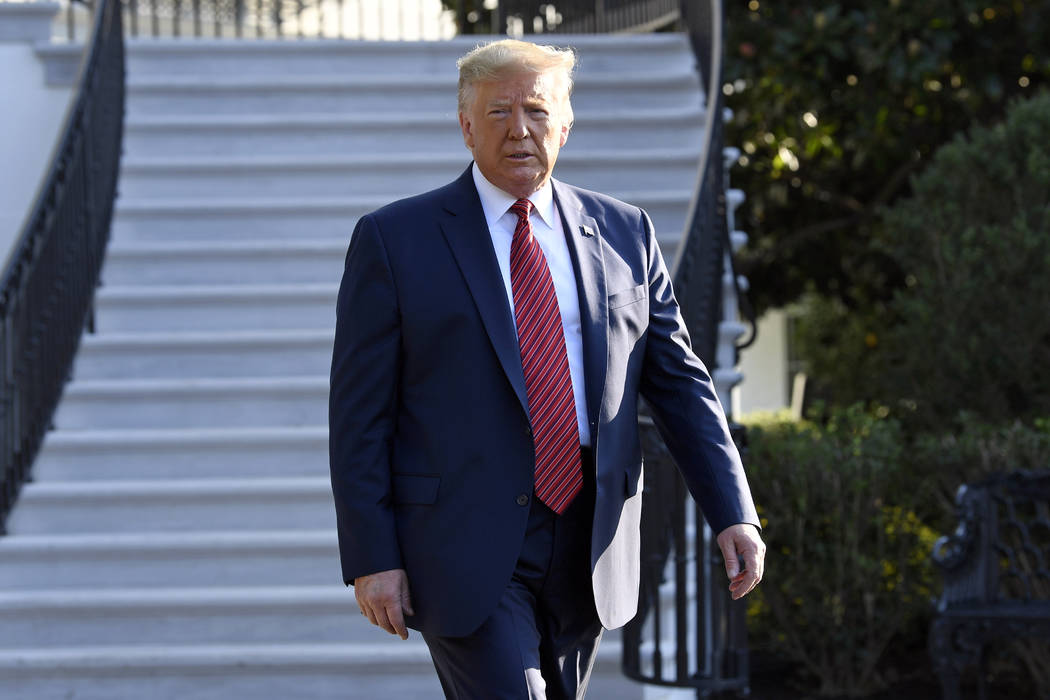 President Donald Trump walks over to talk with reporters on the South Lawn of the White House i ...