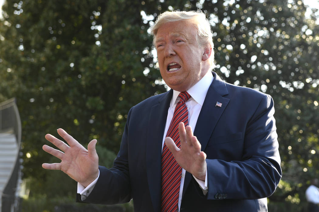 President Donald Trump talks with reporters on the South Lawn of the White House in Washington, ...