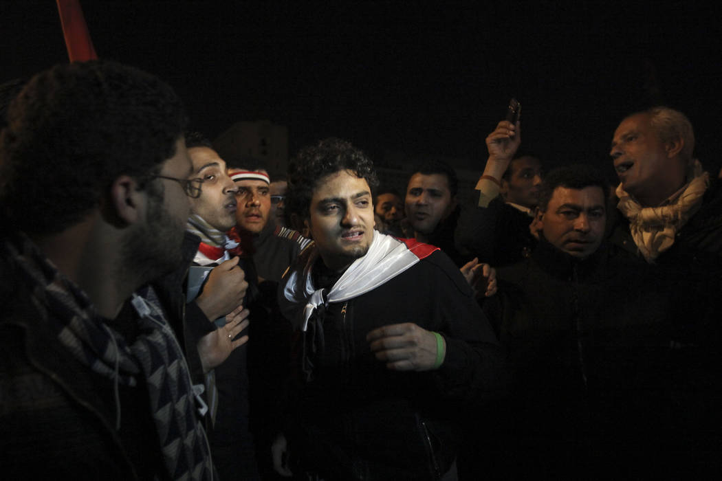 FILE - In this Feb. 10, 2011 file photo, Egyptian Wael Ghonim, center, walks into Tahrir Squar ...