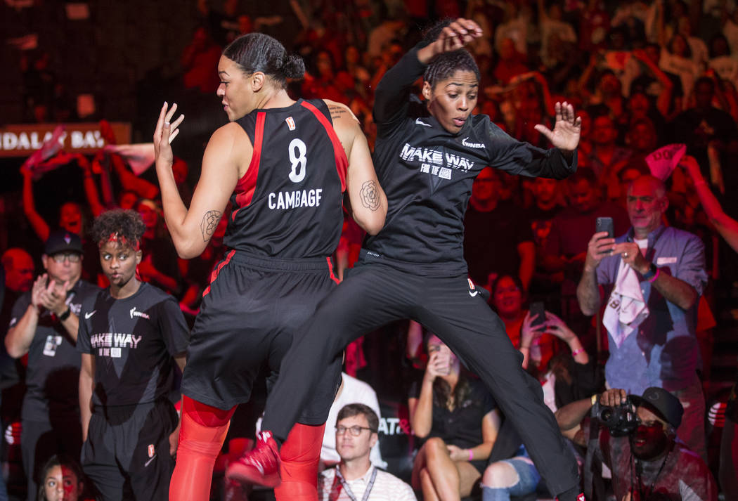 Las Vegas Aces center Liz Cambage (8) gets fired up with teammate Sydney Colson (51) before the ...
