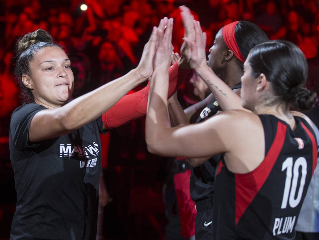 Las Vegas Aces guard Kayla McBride (21) high fives Las Vegas Aces guard Kelsey Plum (10) before ...