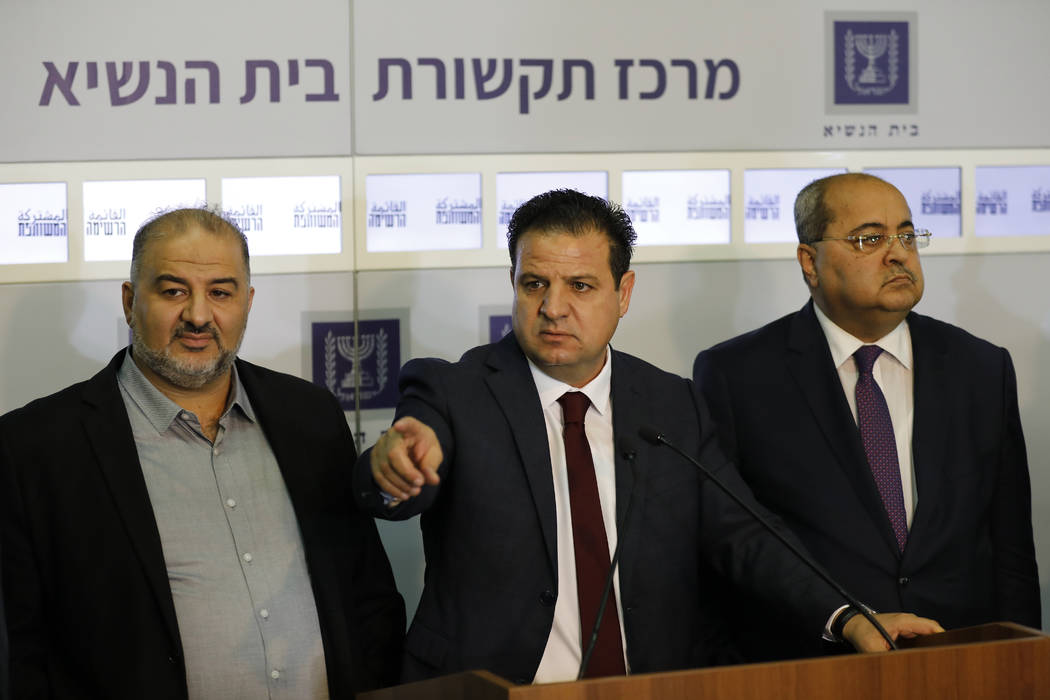 Members of the Joint List Ayman Odeh, center, speaks to the press in the presence of Ahmad Tibi ...