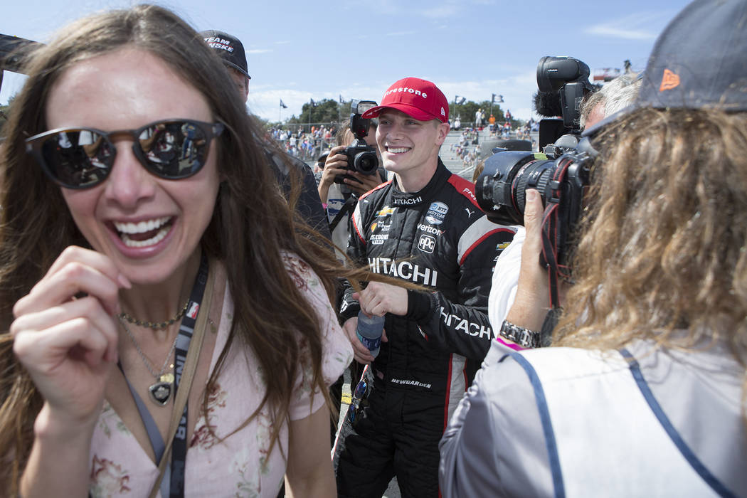 Josef Newgarden, center, and his fiancee Ashley Welch, left, celebrate in his pit after he won ...