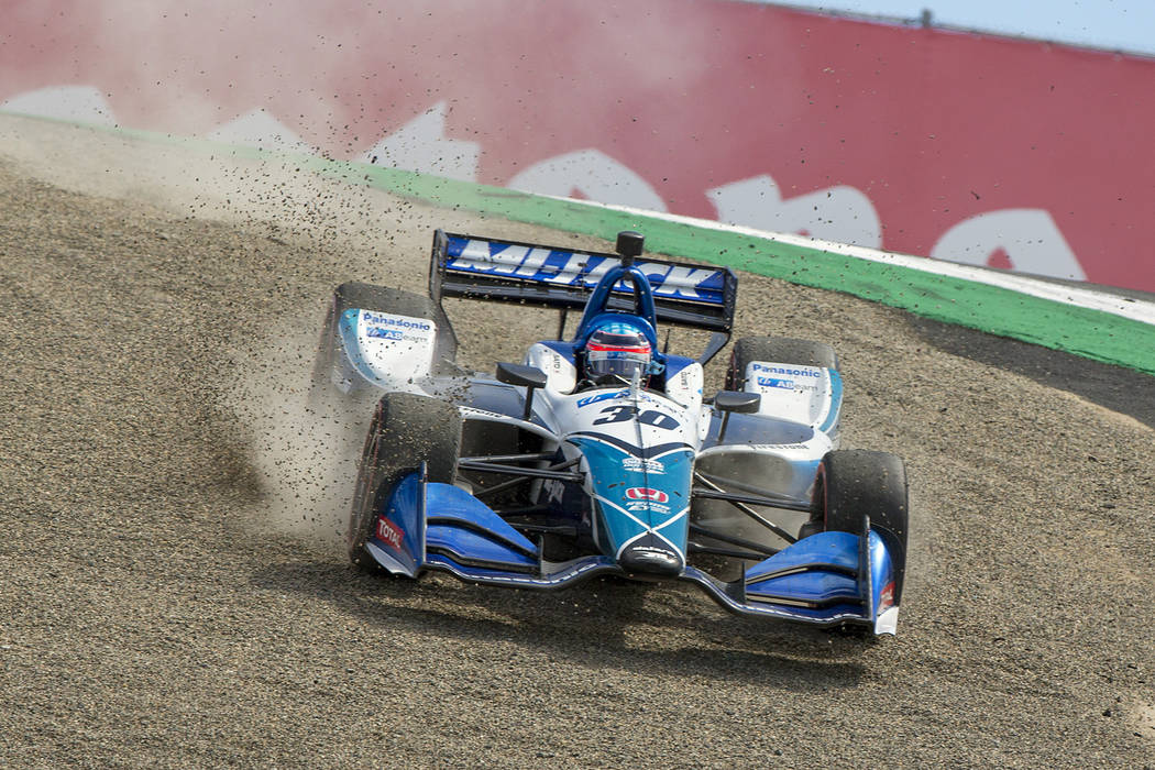 Takuma Sato (30) drives back onto the track after missing the turn at the top of The Corkscrew ...