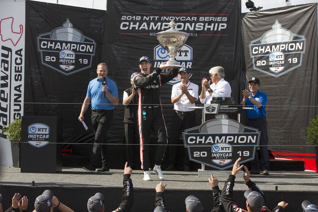 Josef Newgarden raises the trophy in the air after winning the championship after an IndyCar au ...